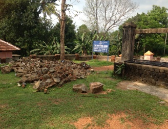 The cleaned well with removed rubble next to it